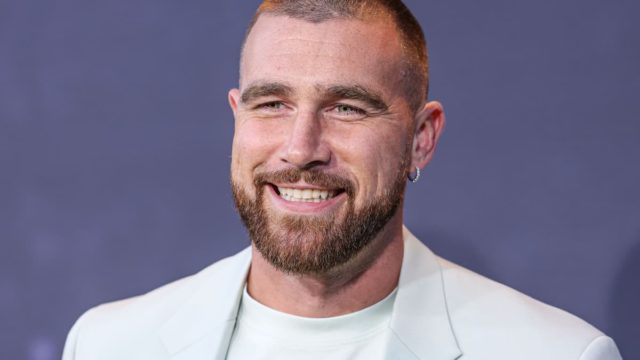 Travis Kelce celebrating a touchdown in a Kansas City Chiefs jersey