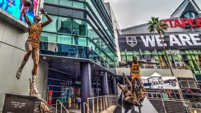Johnson smiling courtside celebrating billionaire success in 2025