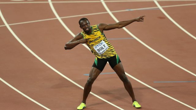 Usain Bolt smiling with medals after winning a race