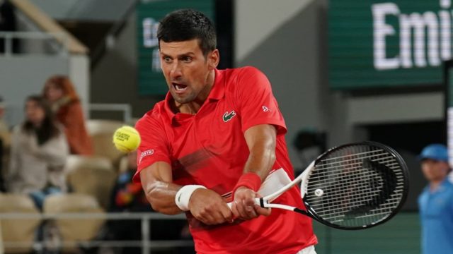 Novak Djokovic celebrates a Grand Slam win in 2025 with trophy in hand