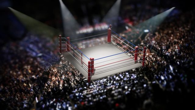 Gervonta Davis celebrating a win in the boxing ring wearing championship belts