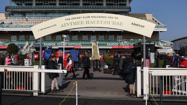 Historic Grand National race at Aintree Racecourse with cheering crowd