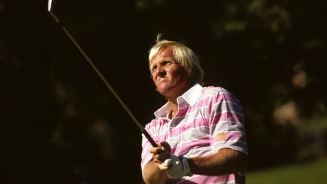 Greg Norman smiling in golf attire on the course, representing his success in sports and business.