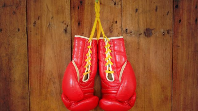 Chris Eubank Sr. standing in the boxing ring with arms raised after a victory