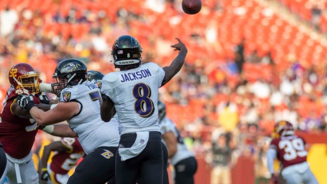 Lamar Jackson on the field celebrating a touchdown in Ravens gear