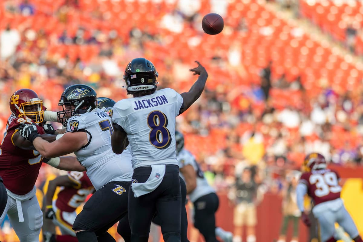 Lamar Jackson on the field celebrating a touchdown in Ravens gear