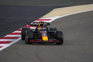 Max Verstappen smiling in Red Bull Racing gear at a Formula 1 track in 2025