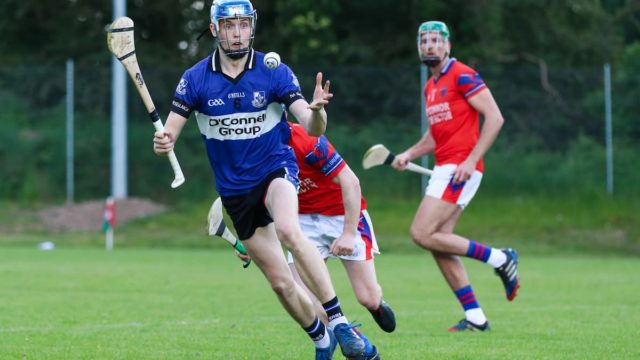 Hurling players competing in a fast-paced Irish sport match