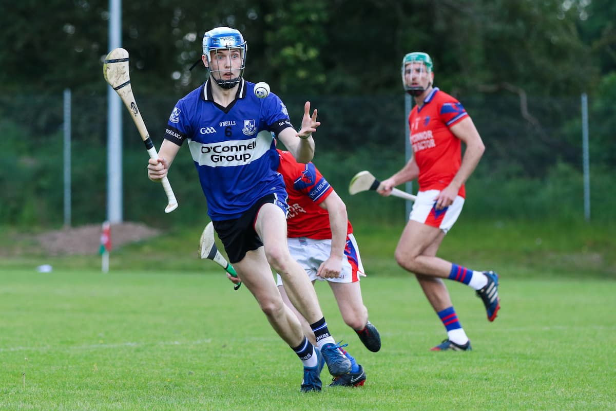 Hurling players competing in a fast-paced Irish sport match