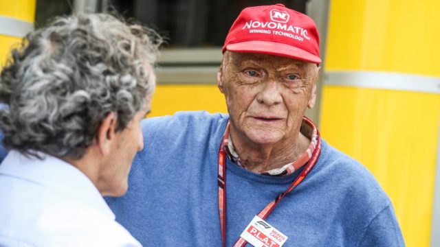 Niki Lauda celebrating Formula 1 victory in Ferrari racing suit
