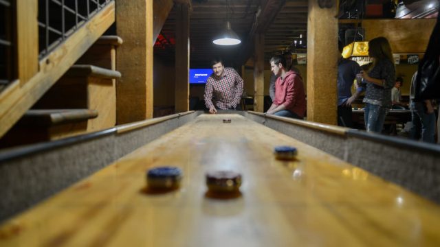 Players enjoying a game of shuffleboard on a court