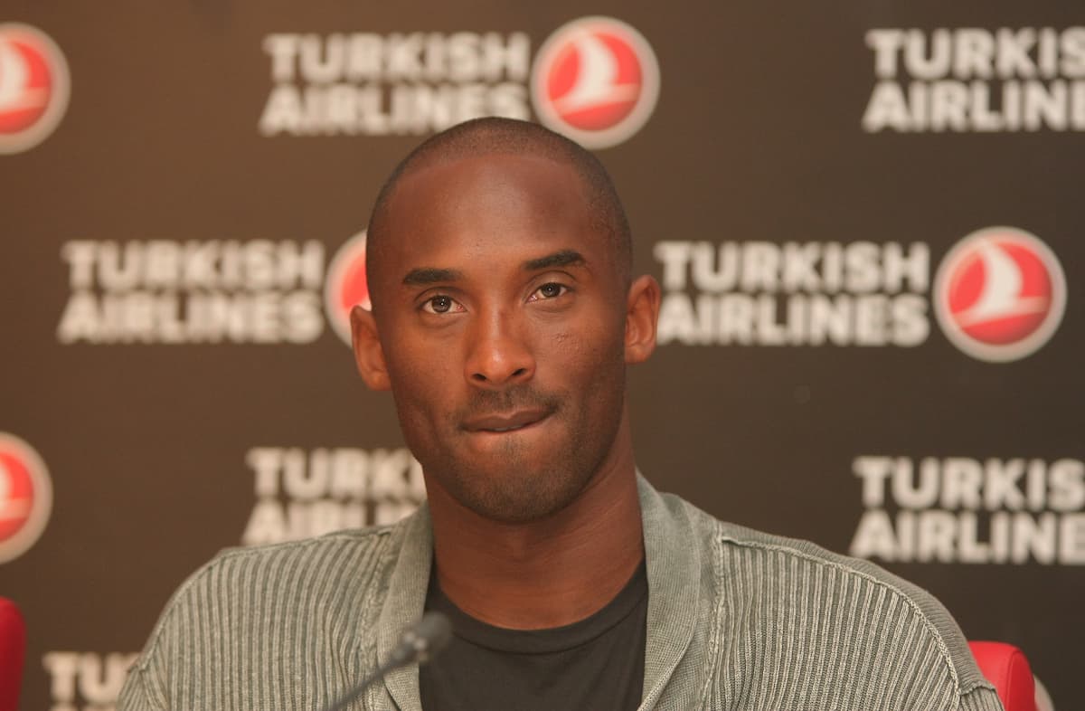 Kobe Bryant smiling during an NBA game in Lakers jersey