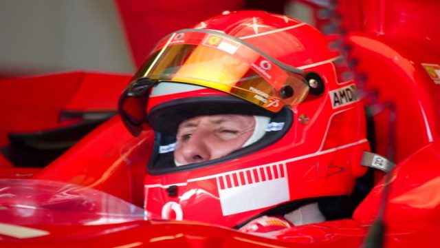 Michael Schumacher waving in Ferrari racing gear after a Formula One win