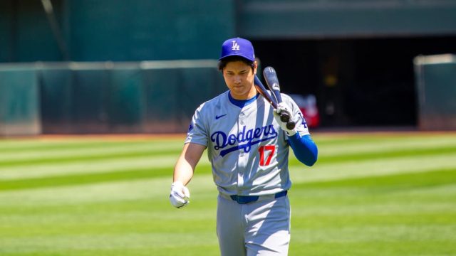 Shohei Ohtani celebrating in a Dodgers jersey with net worth breakdown graphics