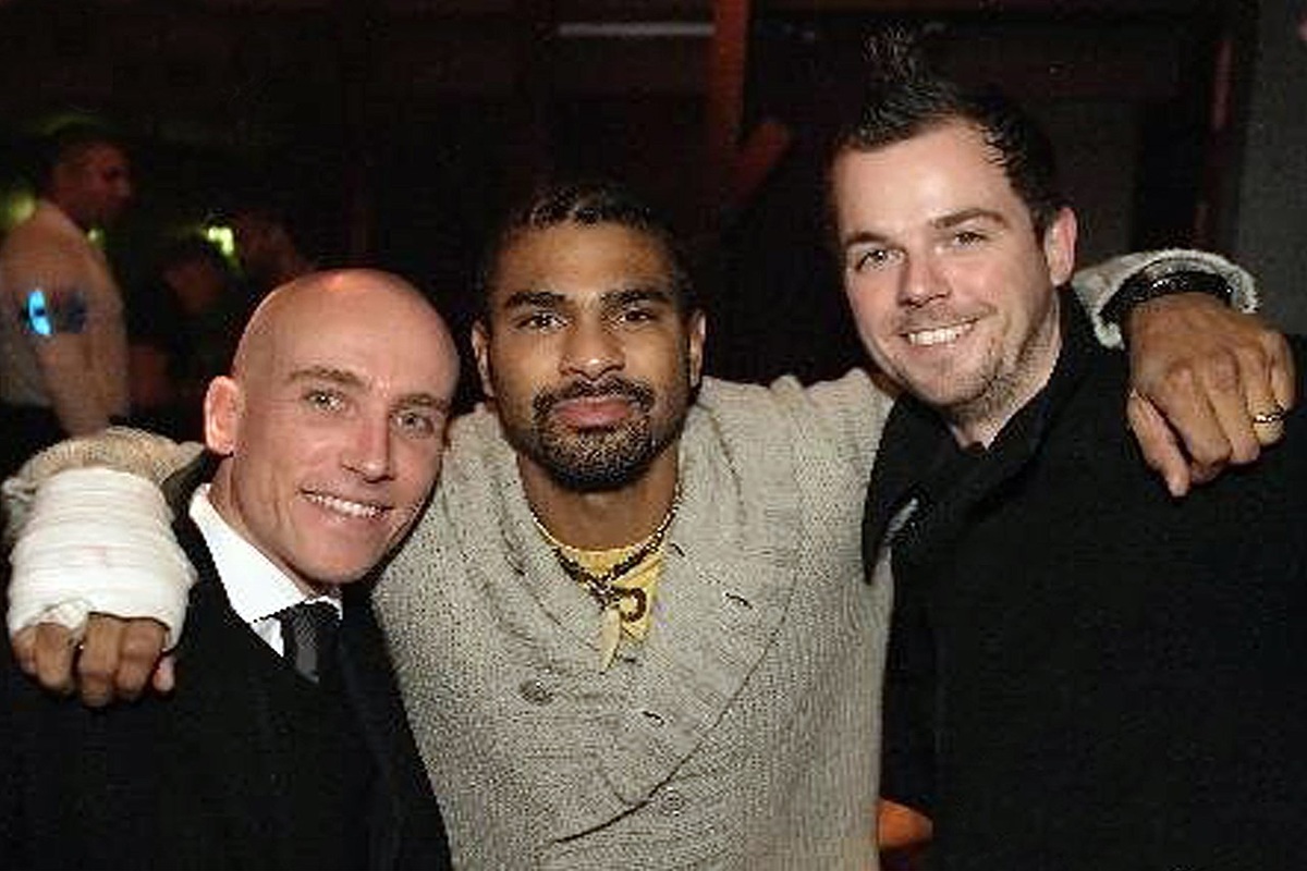 David Haye celebrating a boxing victory in a packed arena ring