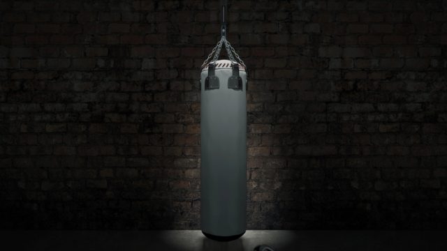 David Tua, the New Zealand heavyweight boxer, throwing a powerful left hook in the ring.