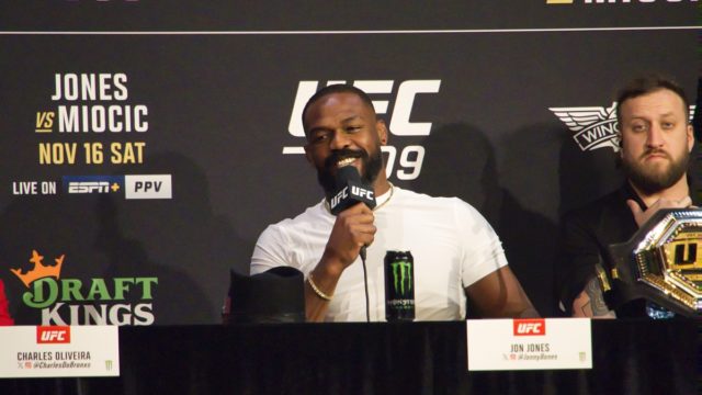 Jon Jones celebrating a UFC title win, highlighting his near-undefeated records