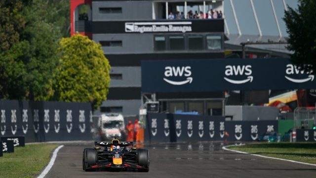 Max Verstappen celebrating a Formula 1 victory in Red Bull overalls, representing his record-breaking F1 salary in 2025.