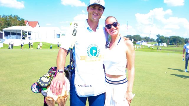 Paige Spiranac wearing a teal top and white skirt at a PGA Tour creator event