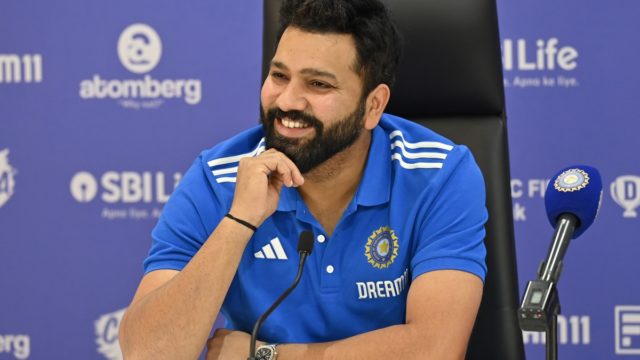 Rohit Sharma celebrating a century for India in a blue ODI shirt, symbolising his net worth and success