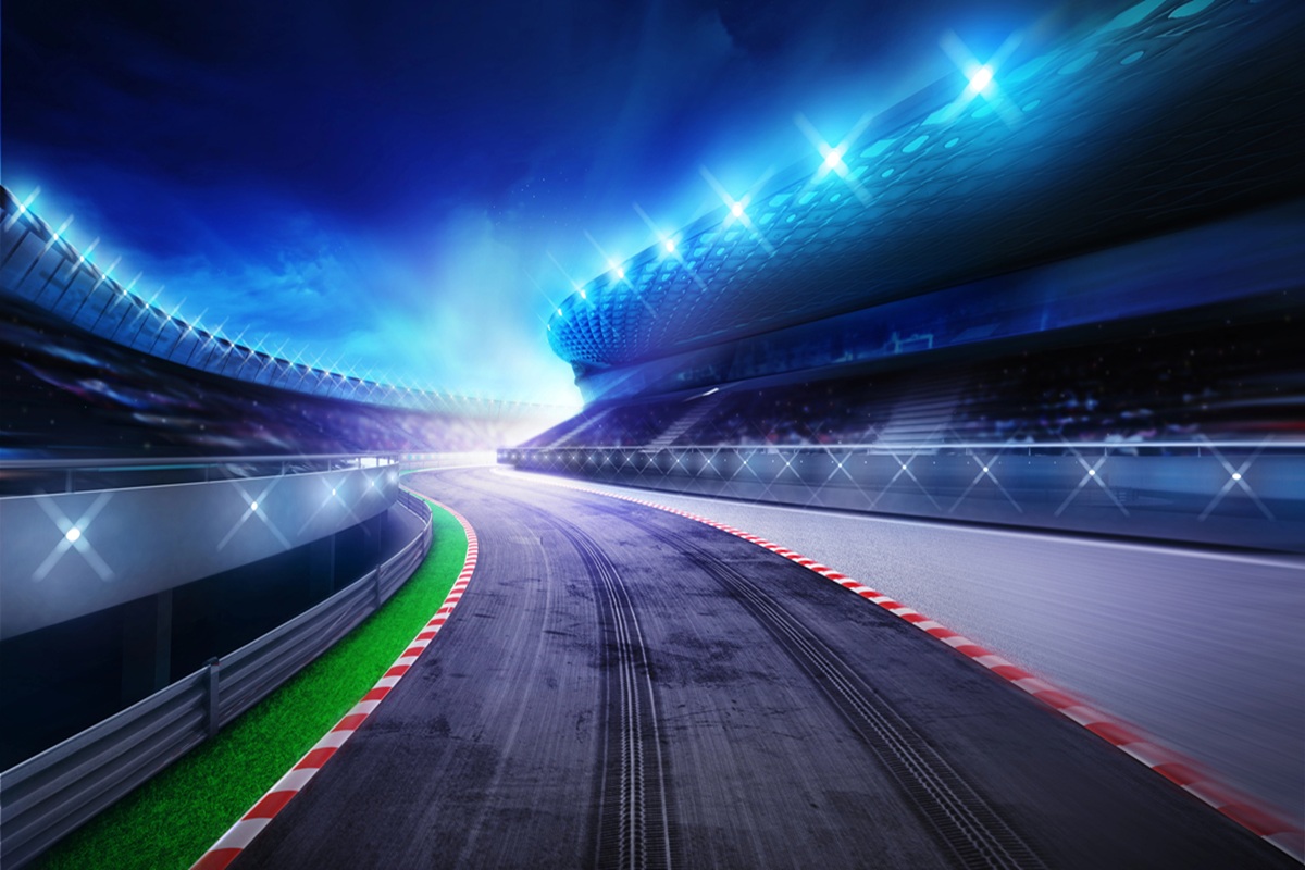 Overhead view of the full Formula 1 grid lined up on the start straight, representing modern F1 team budgets in the cost cap era