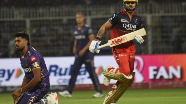 IPL auction table showing franchise staff studying player salary lists and contracts for the new season