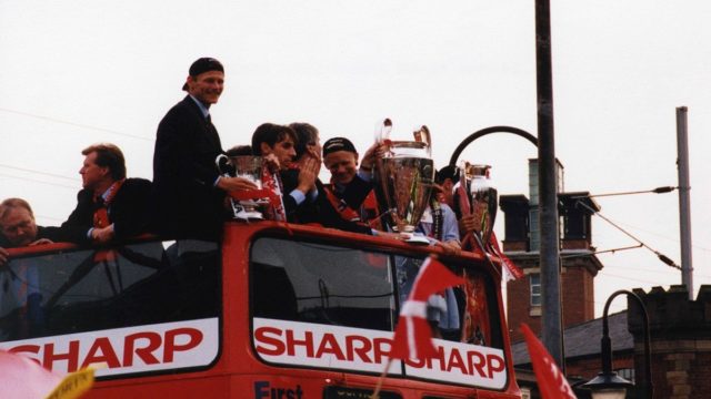 Manchester United players celebrate the 1999 treble with the Champions League trophy