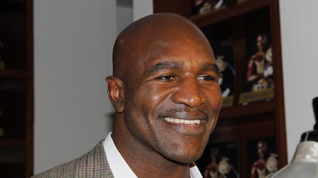 Evander Holyfield celebrating after a heavyweight title fight