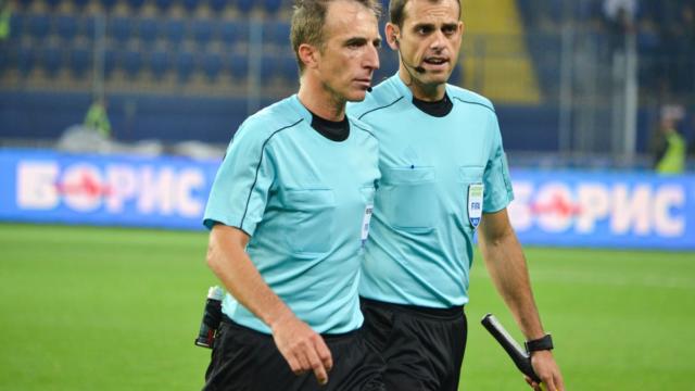Fourth official holding substitution board on football touchline