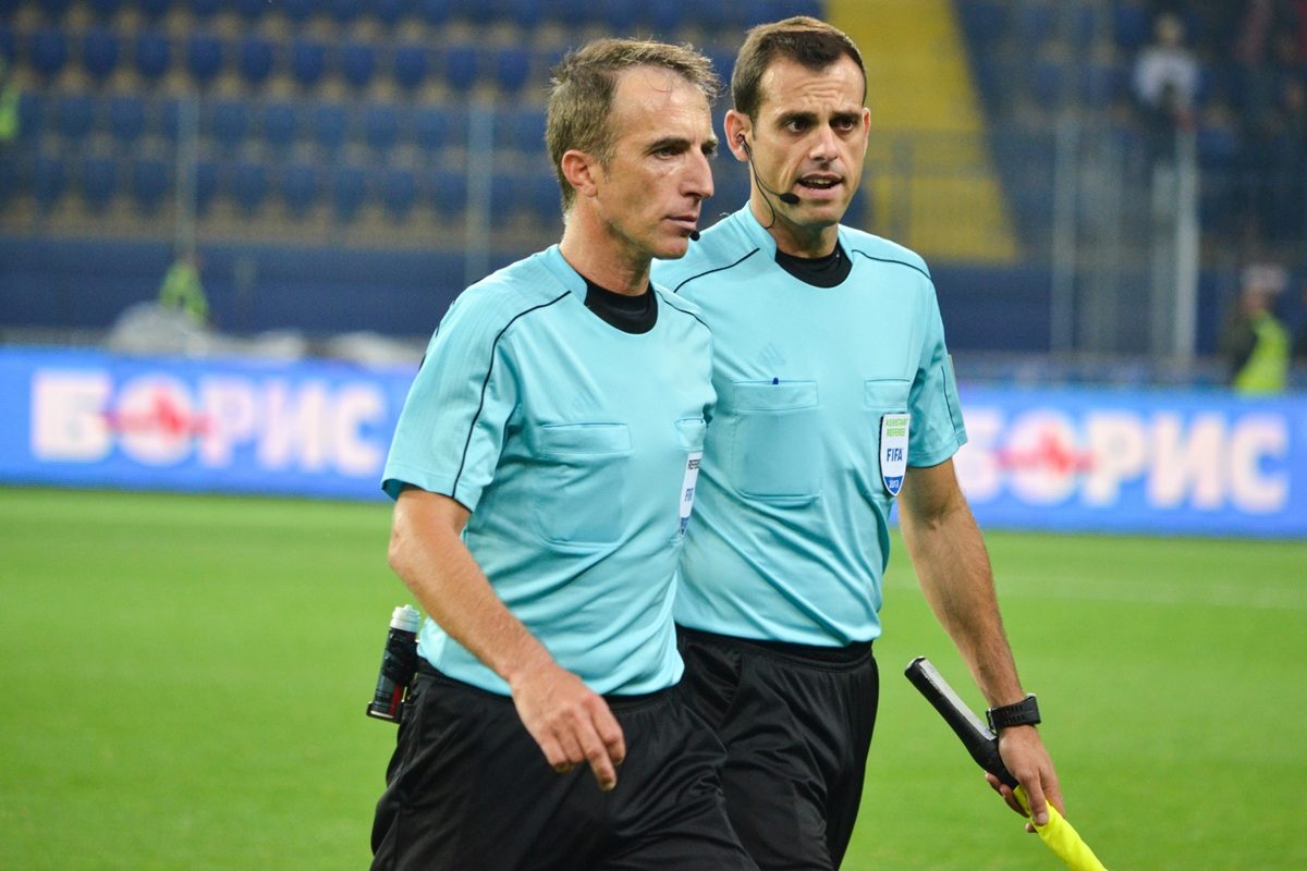Fourth official holding substitution board on football touchline