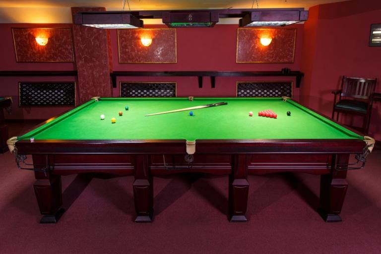 Snooker table with reds, colours and cue ball during a frame as snooker rules are explained