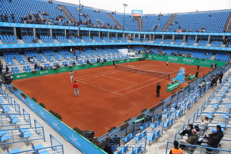 Tennis player serving during a match as part of a tennis rules explained guide