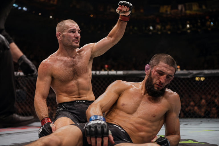 Sean Strickland celebrates after defeating Khamzat Chimaev at UFC 328 in a dramatic middleweight fight scene.